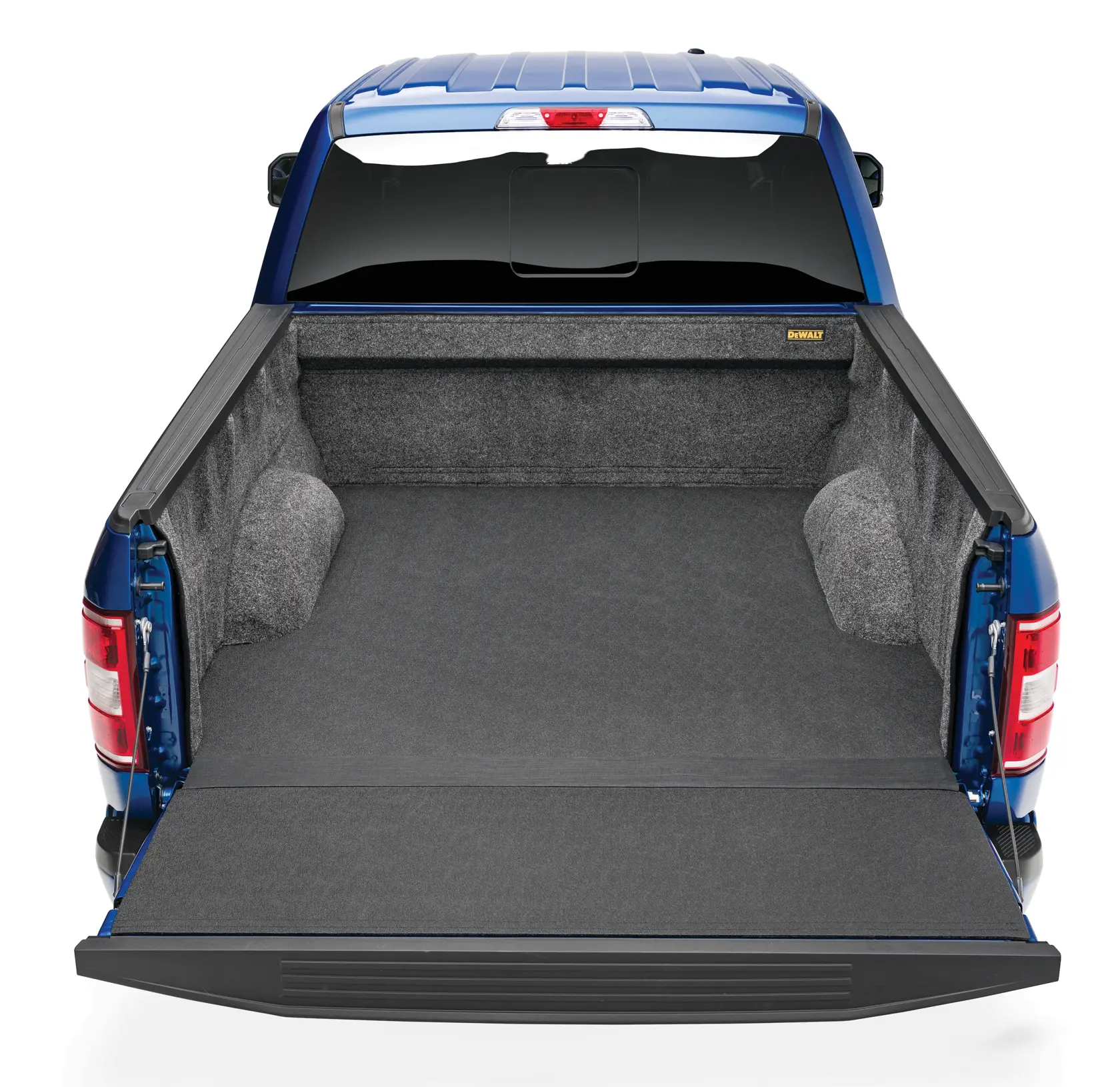 A blue pickup truck with its tailgate down, showing a gray carpeted bed liner by DEWALT installed in the truck bed.